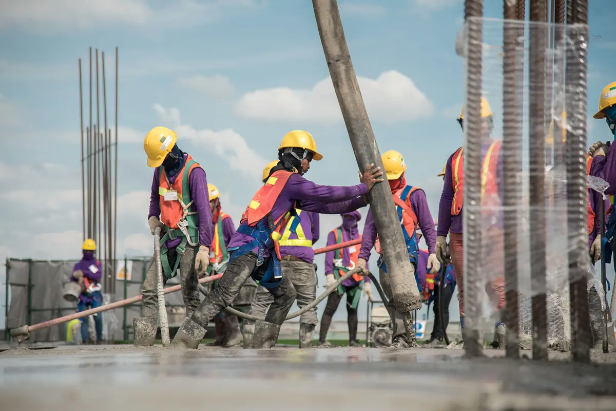 Labour hire crew in hi-vis and hard hats working on a concrete pour in Sydney