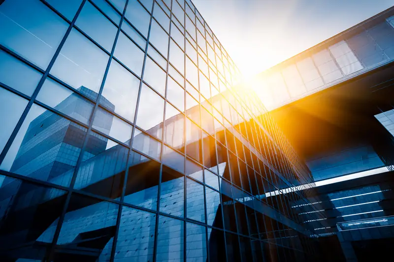 Glass commercial tower reflecting the sun